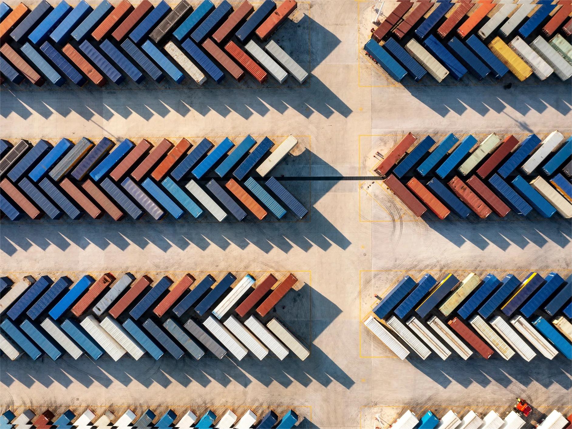 Cargo ships and containers at a busy port, symbolizing global logistics
