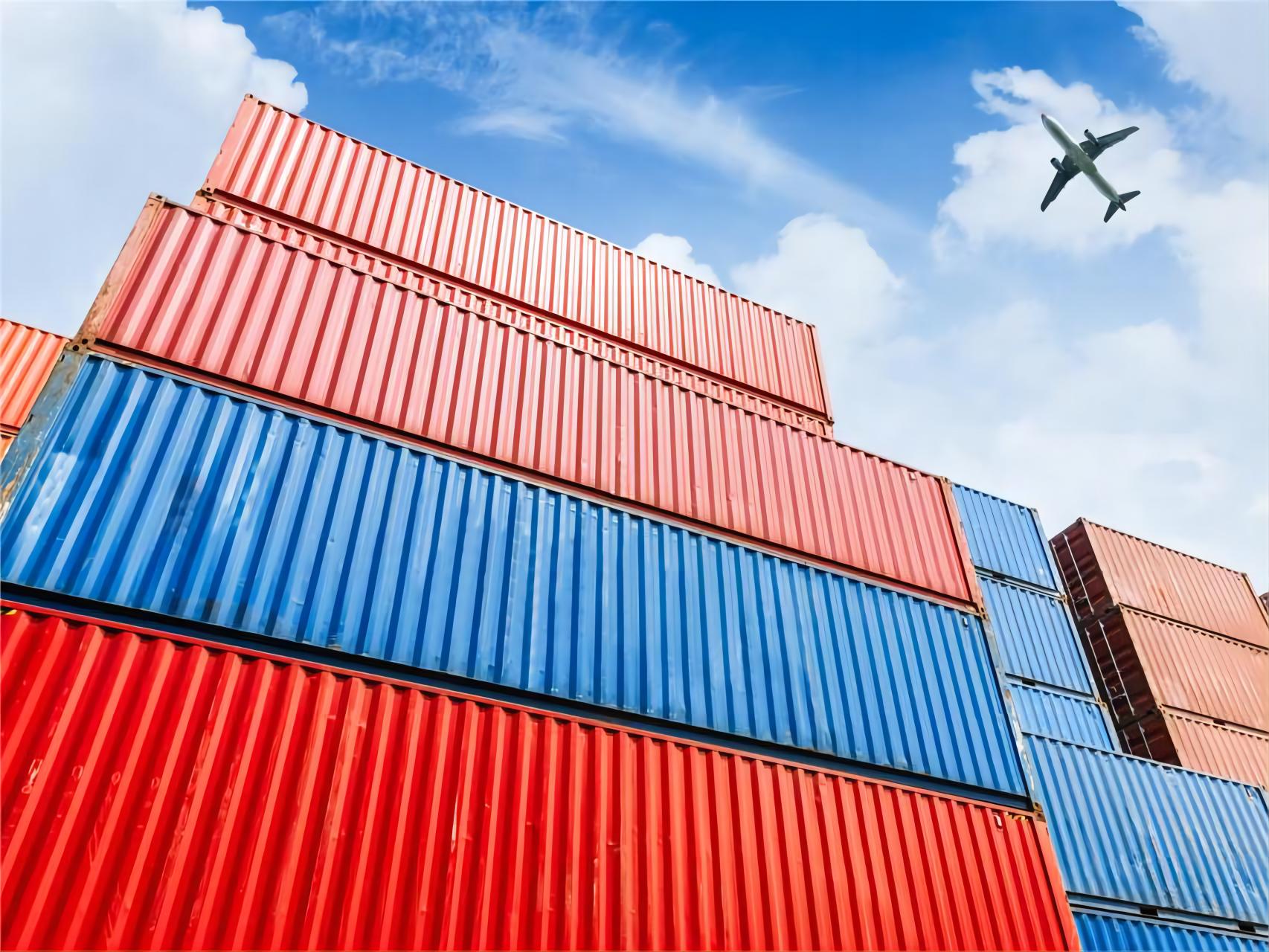 Shipping containers being loaded onto a train at a busy rail terminal