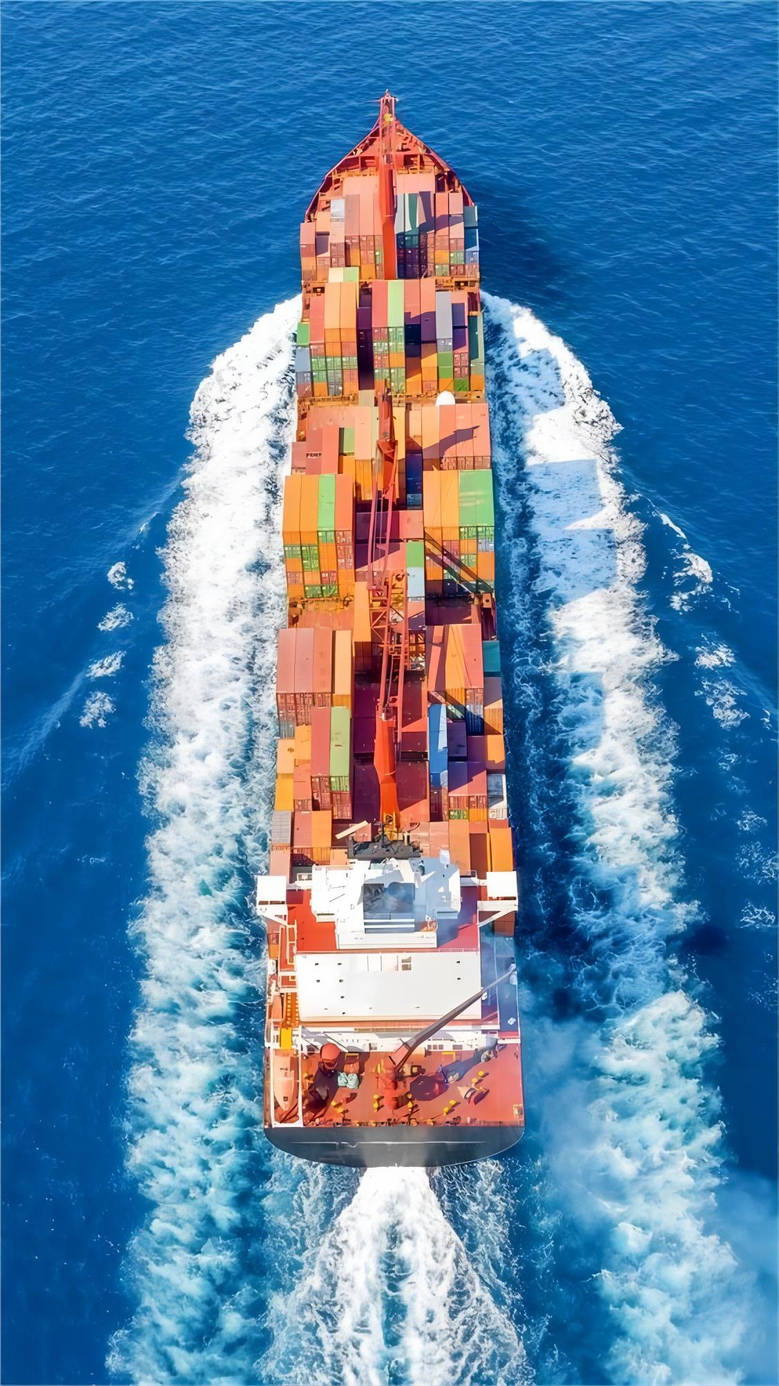 Open top container being loaded with large auto parts at a port