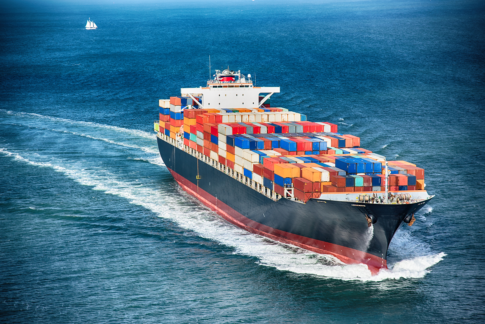 Oversized hardware tools loaded onto a flat rack container at a port